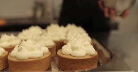 Sprinkle and decorate mini tarts with grated nuts. Stock Footage 252425307