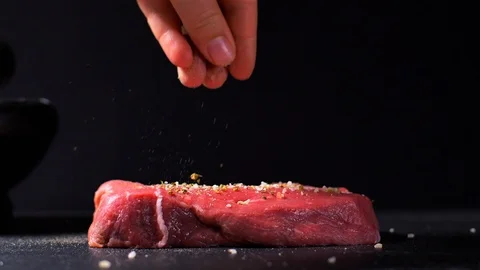 Sprinkle beef steak with salt and pepper slow motion Stock Footage 114078583