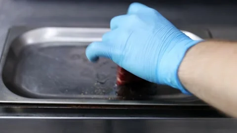 Sprinkle black pepper on beef steak. Preparing meat for frying. Stock Footage 165941195