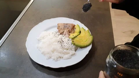 Sprinkle black sesame seeds on top of rice Stock Footage 159141353