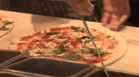 Sprinkle cheese on pizza Stock Footage 64024759