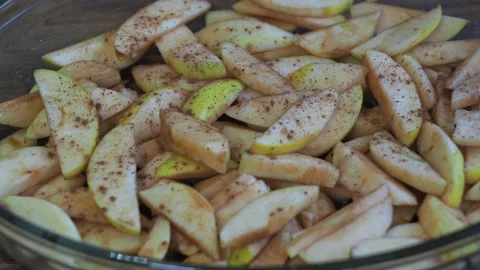 Sprinkle cinnamon apples in the form. cooking a pie with yalokami Stock Footage 167797067