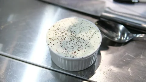 Sprinkle cocoa on Tiramisu. Hand sprinkle cocoa powder on top of a tiramisu cake Stock Footage 282370935