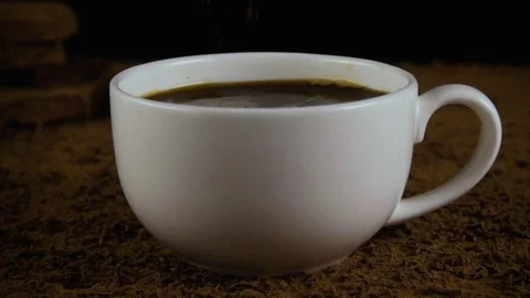 Sprinkle coffee in a cup of cinnamon. Slow mo Stock Footage 75313107