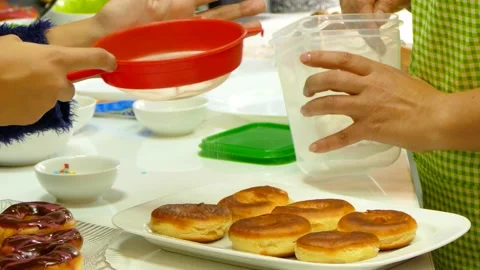 Sprinkle the donuts with powdered sugar Stock Footage 86114433