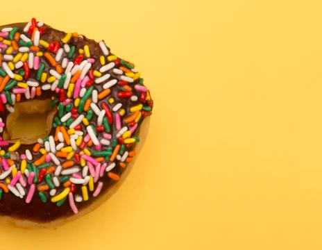Sprinkle Donuts on a Yellow Background Stock Photos