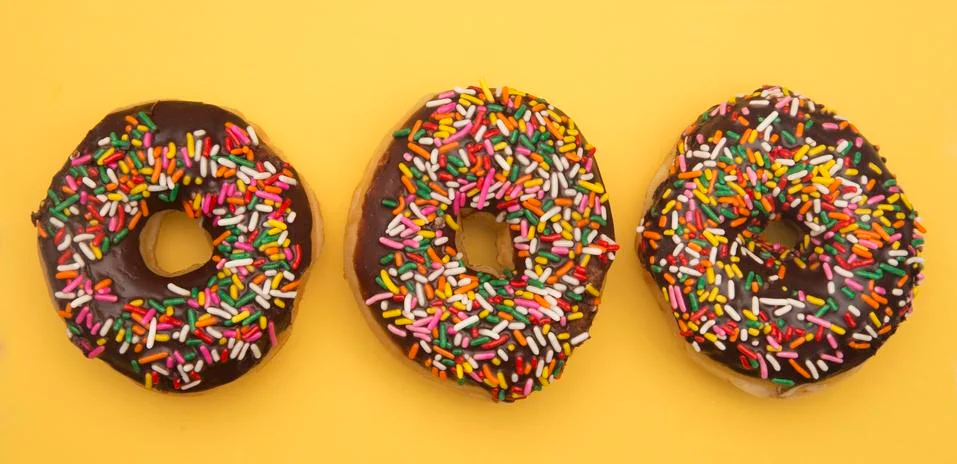 Sprinkle Donuts on a Yellow Background Foto stock