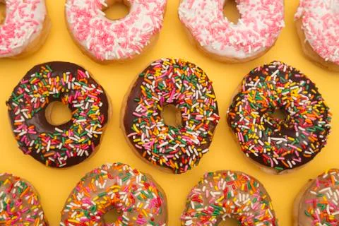 Sprinkle Donuts on a Yellow Background Stock Photos