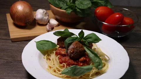 Sprinkle drop garnishing basil on cheese powder on meatball sauce cooked spaghet Stock Footage 156836698