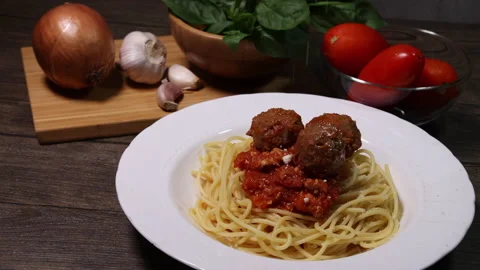 Sprinkle drop garnishing basil on cheese powder on meatball sauce cooked spaghet Stock Footage 156836884