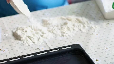 Sprinkle flour on the kitchen table. Baking. Stock Footage 185729232