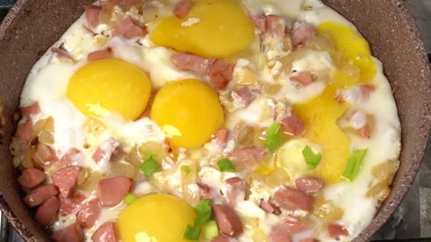 Sprinkle the fried bacon and eggs with chopped green onions. homemade food. Stock Footage 148148919