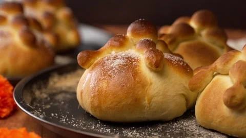 Sprinkle granulated sugar over freshly baked homemade breads of the dead Stock Footage 281459949