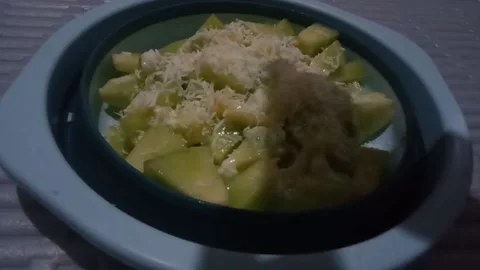 Sprinkle grated cheese over fruit salad Stock Footage 232556277