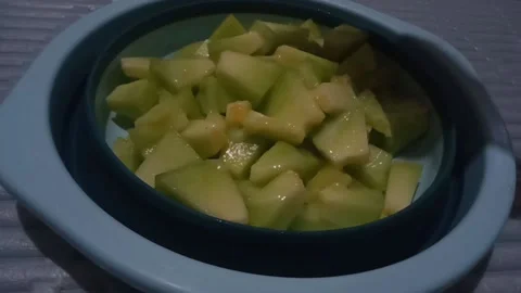 Sprinkle grated cheese over fruit salad Stock Footage 232556308