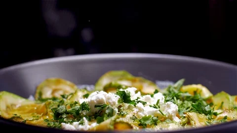 Sprinkle with parmesan on a dish with zucchini Stock Footage 105131614