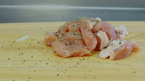 Sprinkle pork with salt on the table Stock Footage 70977211