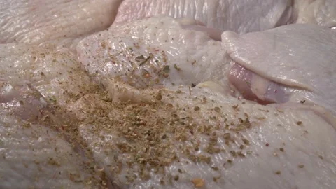 Sprinkle raw chicken with spices. Close-up meat. Stock Footage 143783152