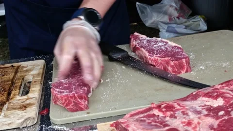 Sprinkle raw steak with salt Stock Footage 181449358