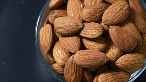 Sprinkle salt on almonds nut. product rich in minerals and vitamins. Stock Footage 132617095