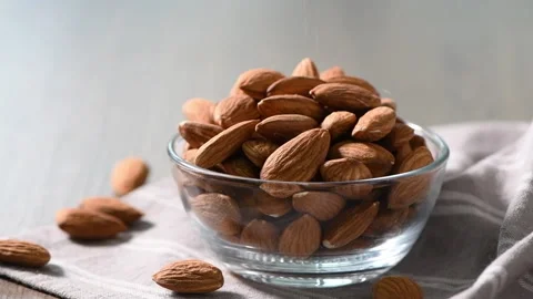 Sprinkle salt on almonds nut. slow motion and side view. Stock Footage 132617888
