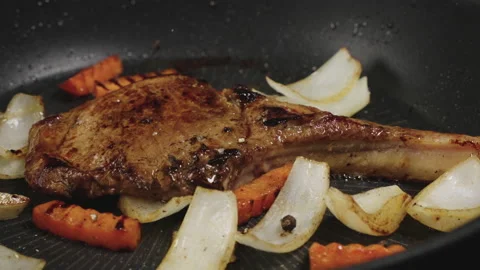 Sprinkle salt and black pepper over fried pork chops. Stock Footage 177886602