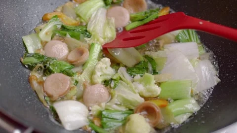 Sprinkle salt on the capcay dish in the pan and stir. Capcay or chop suey (.. Stock Footage 329704096