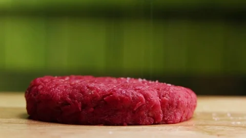 Sprinkle with salt raw beef burger Stock Footage 73764921