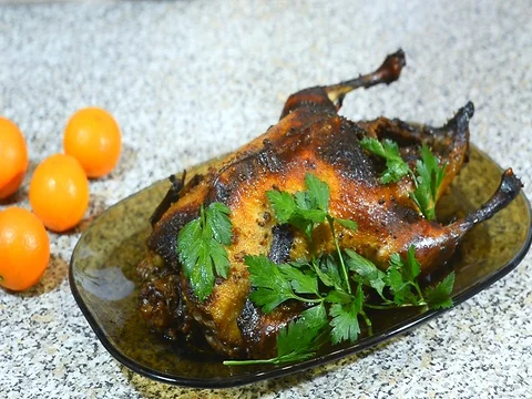 Sprinkle with spices,  roasted  duck on a platter with potatoes and greens Stock Footage 72715713