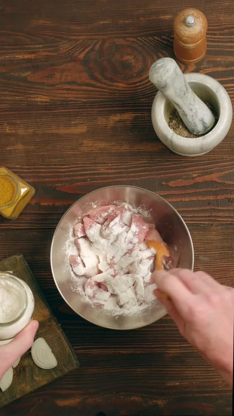 Sprinkle thinly sliced raw pork strips with corn starch and spices Stock Footage 345481666