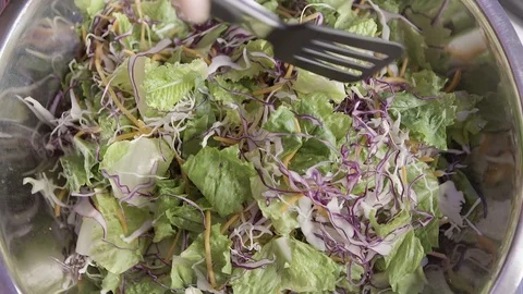 Sprinkle the vegetables in Mixed Variety Slice and Shredded Vegetables bowl Stock Footage 128678199