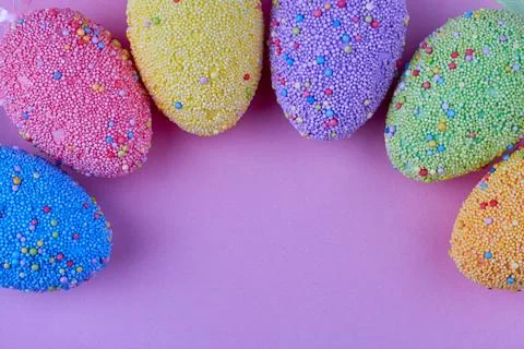 Sprinkled easter eggs and copy space. Stock Photos