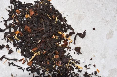 Sprinkled tea on a light gray table Stock Photos