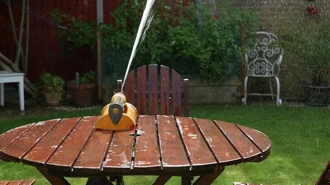 Sprinkler on garden table - Slow motion - Wide shot 動画素材 106034494