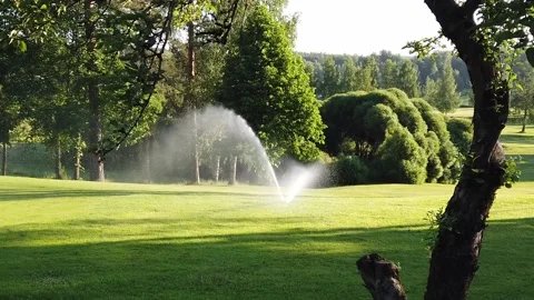 Sprinkler on a golf course in slow motion Stock Footage 134145026