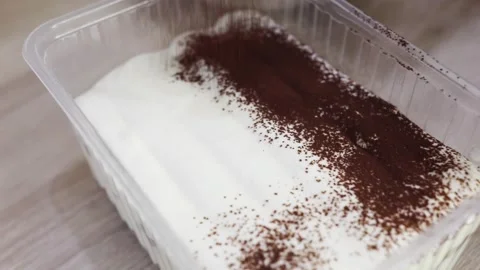 Sprinkling cake with cocoa, top, close up, slow motion Video stock 276364162