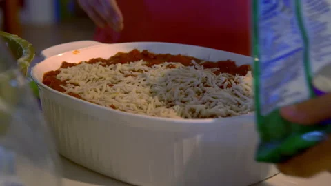 Sprinkling cheese on dish before baking Stock-Footage 135753659