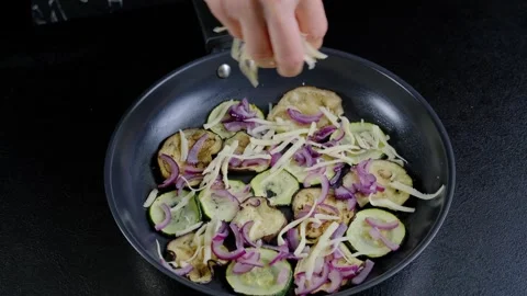Sprinkling Cheese into Pan of Vegetables Cooking Stock-Footage 341418409