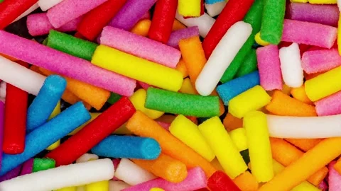 Sprinkling confectionery multi colored long cylinders close-up, rotating Stock-Footage 242361759