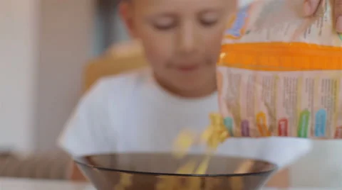 Sprinkling corn flakes in a bowl Stock Footage 40331705