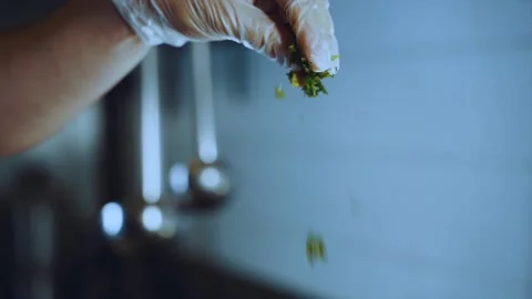 Sprinkling the dish with herbs in slow motion Stock Footage 201757059
