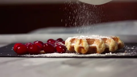 Sprinkling dusting of sugar on waffles with ripe cranberries Stock-Footage 333636429