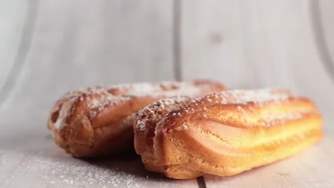 Sprinkling eclairs with powdered sugar Stock Footage 168754112