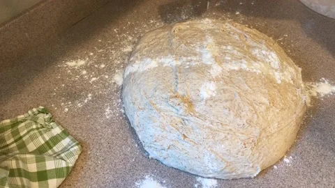 Sprinkling Flour on Bread Dough Stock Footage 134215054
