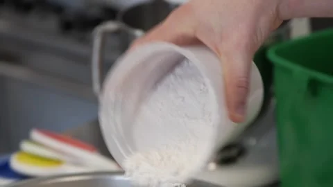 Sprinkling flour into the dough mix Stock-Footage 307339927