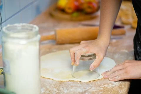 Sprinkling flour over flat raw dough layer photo 库存照片