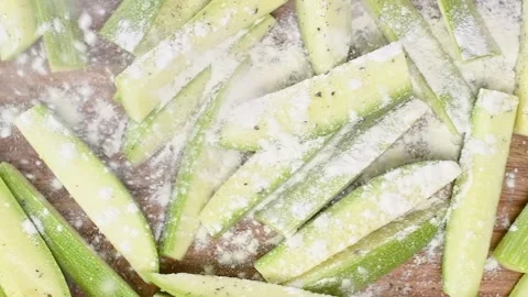 Sprinkling flour on sliced courgettes . 스톡 동영상 150890087