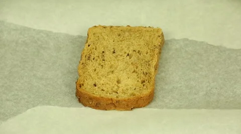Sprinkling grated cheese bread Stock Footage 66693829