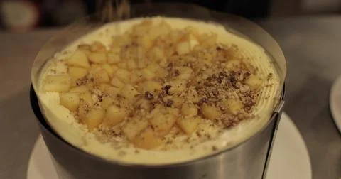 Sprinkling ground nuts on the cake during cooking. A professional confectio.. Stock Photos