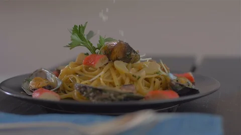 Sprinkling with Parmesan. Seafood paste and mussels Stock Footage 111669570